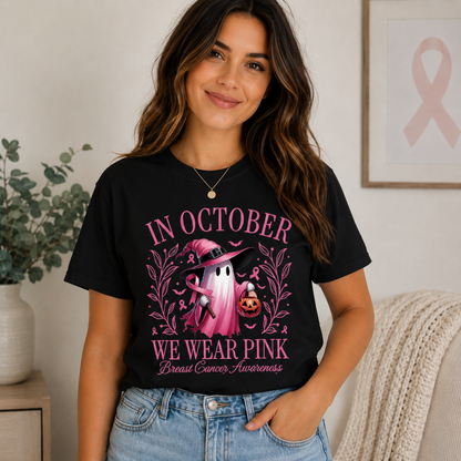 A girl wearing a black t-shirt with a graphic design "In October we wear pink text with a ghost and pumpkin design