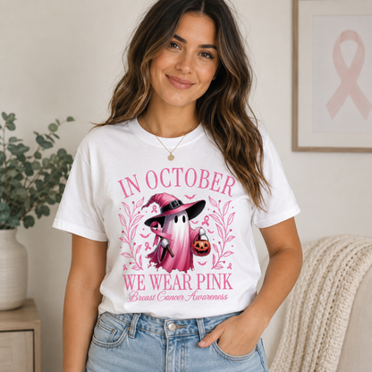 A girl wearing a white t-shirt with a graphic design "In October we wear pink text with a ghost and pumpkin design