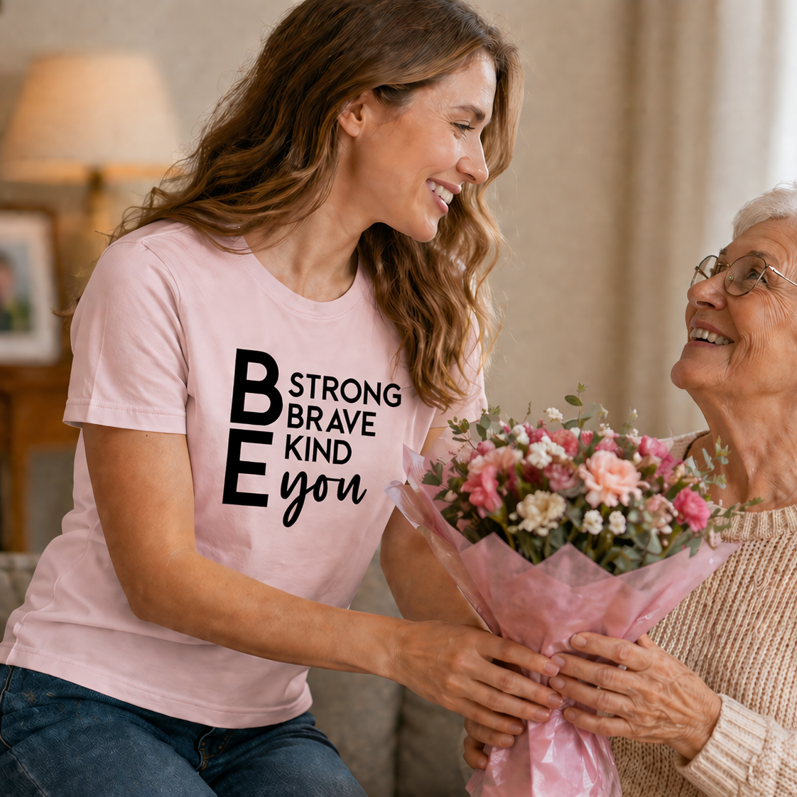A woman wearing a light pink colored t-shirt with motivational text.