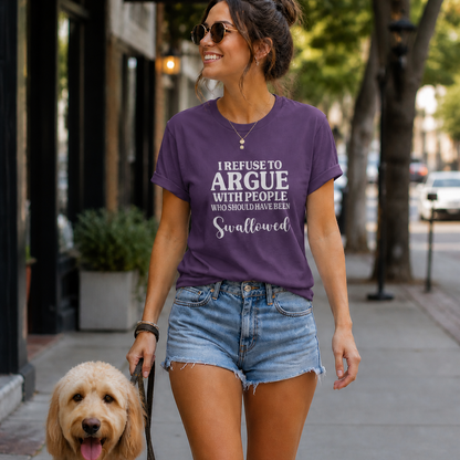Woman walking a dog on a city street wearing a purple t-shirt with text.