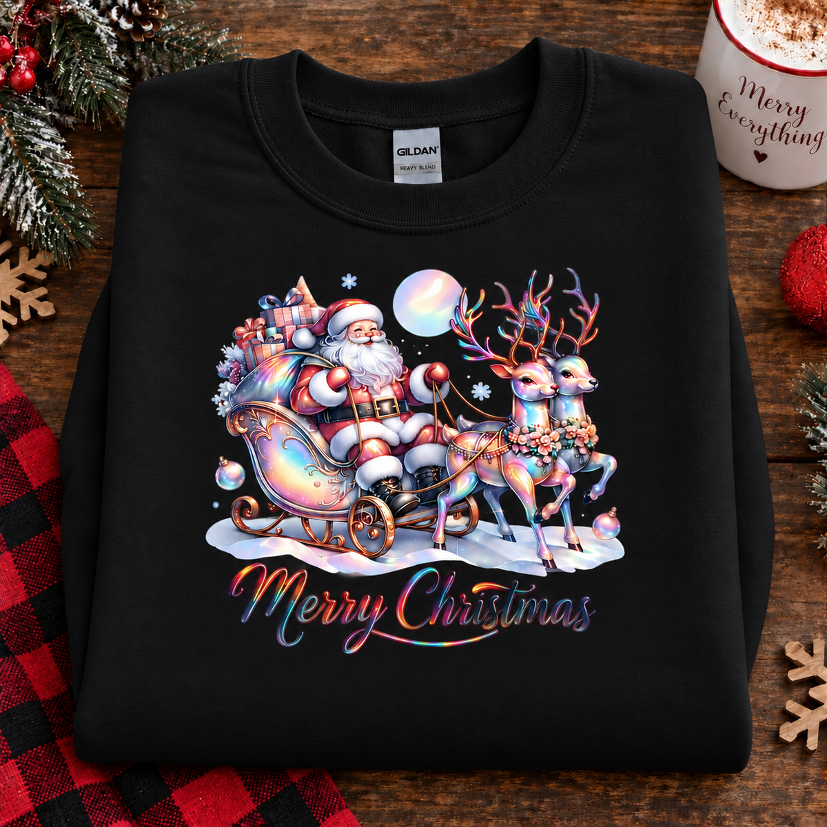 A black Gildan sweatshirt featuring a colorful Christmas graphic of Santa Claus in a sleigh pulled by reindeer under a full moon, with 'Merry Christmas' written below, displayed on a rustic wooden background with holiday decorations.