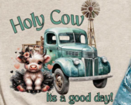 Graphic t-shirt with a Highland cow in a black tutu standing next to a vintage truck, blending fun and country charm.