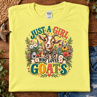 A folded yellow Gildan t-shirt with a colorful graphic of a goat surrounded by flowers and the text 'JUST A GIRL WHO LOVES GOATS'.