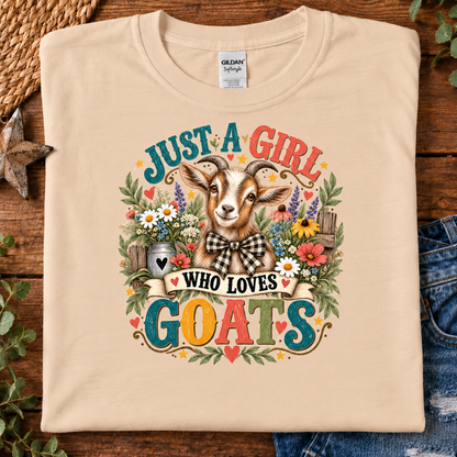 A natural Gildan t-shirt with a colorful graphic print of a goat and the text 'JUST A GIRL WHO LOVES GOATS'.
