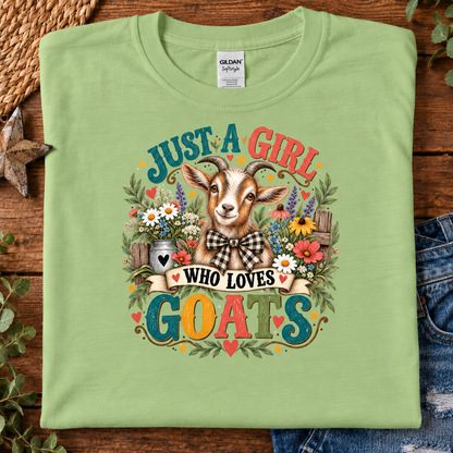 A folded pistachio green Gildan t-shirt with a colorful graphic of a goat surrounded by flowers and the text 'JUST A GIRL WHO LOVES GOATS'.