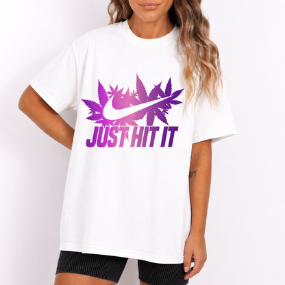 White t-shirt with purple Nike logo and 'Just Hit It' text worn by a person on a white background