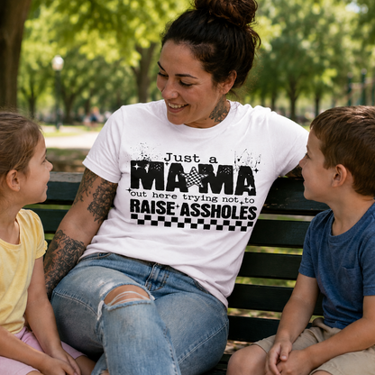 Woman sitting on a park bench with two children, wearing a white t-shirt with text.