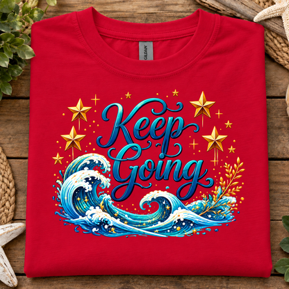 Red colored t-shirt with a ocean and stars graphic with text Keep Going
