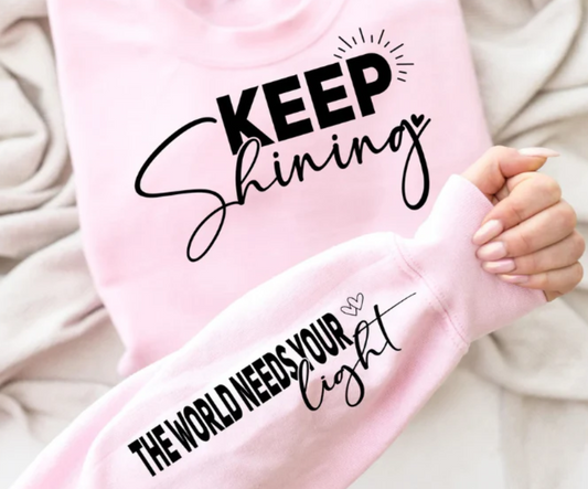 Keep Shining The World Needs Your Light graphic sweatshirt with inspirational sleeve detail