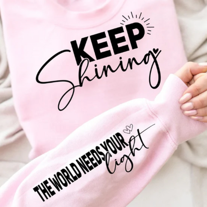 Light pink sweatshirt with the inspirational saying "Keep Shining the World Needs Your Light".