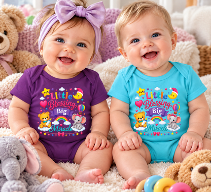 Two smiling babies sitting on a plush rug surrounded by toys, wearing matching colorful bodysuits with a cartoon rainbow design that reads 'Little Blessing Big Miracle.' One baby wears a purple bodysuit and a lavender bow headband, and the other wears a turquoise bodysuit.