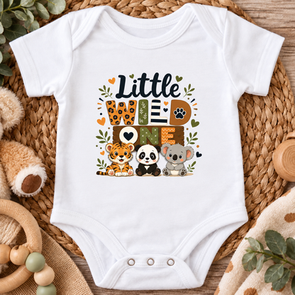 A white short-sleeve baby bodysuit laid flat on a woven straw mat, featuring a colorful 'Little We Love Nature' graphic with cartoon animals including a tiger, panda, and koala.