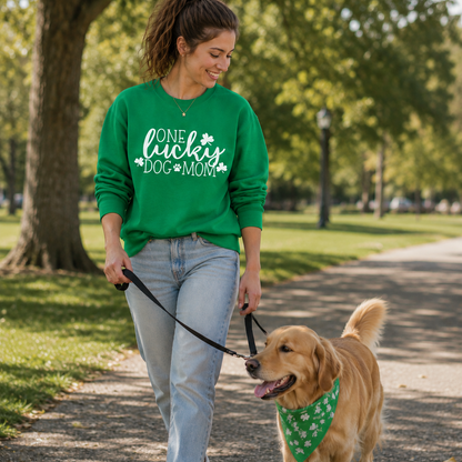 Woman walking a dog on a leash in a park wearing a green sweatshirt with One Lucky Dog Mom text.