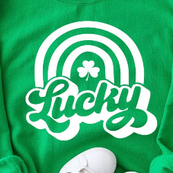 Green shirt with white rainbow and shamrock design on a green background