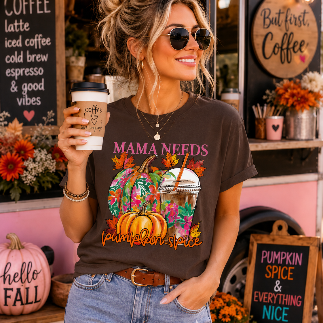 Woman holding a coffee cup in front of a coffee truck with 'Pumpkin Spice & Everything Nice' sign.