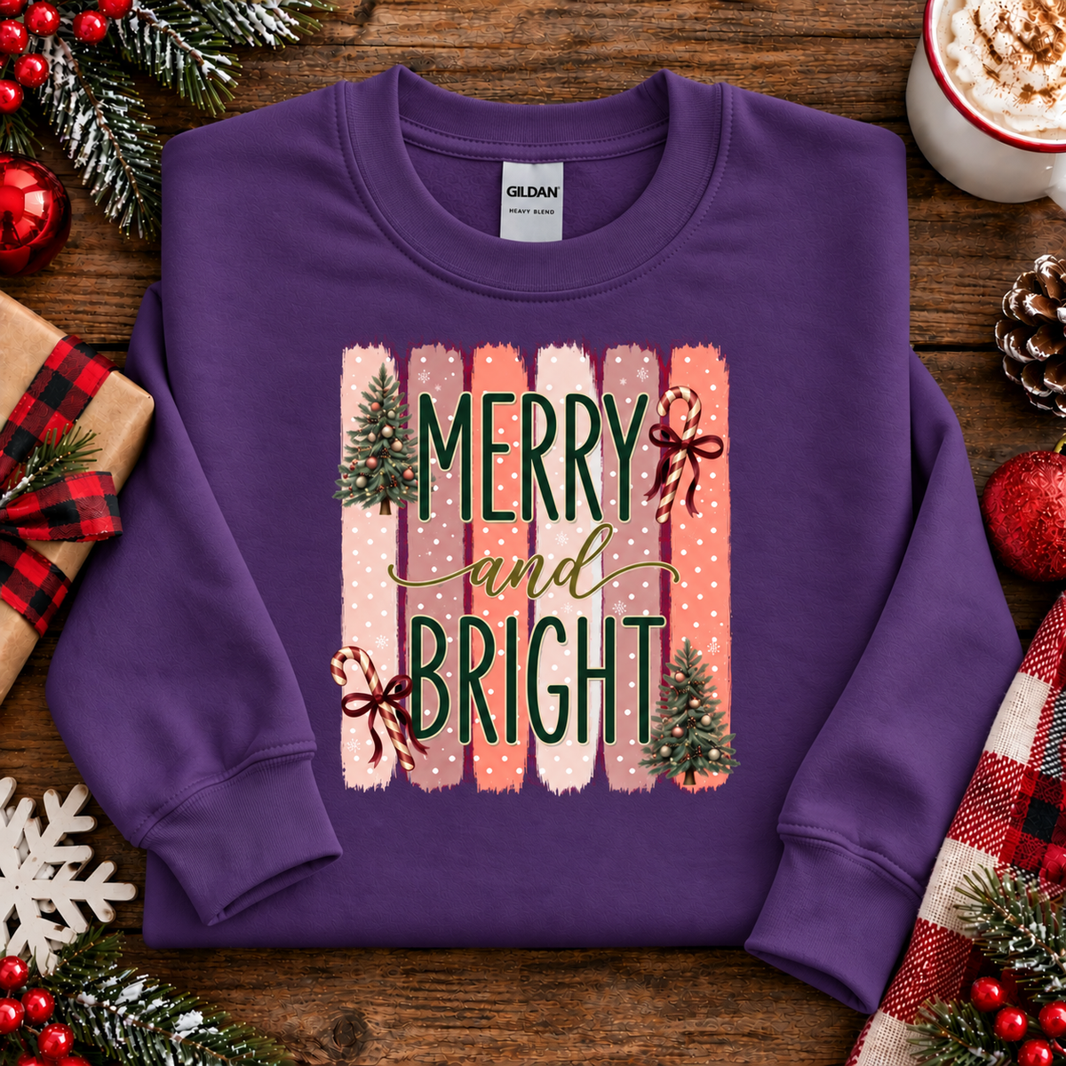 Merry and Bright Christmas graphic on a purple sweatshirt with striped pink and coral background, white polka dots, green lettering, candy canes with red bows, and two decorated Christmas trees.