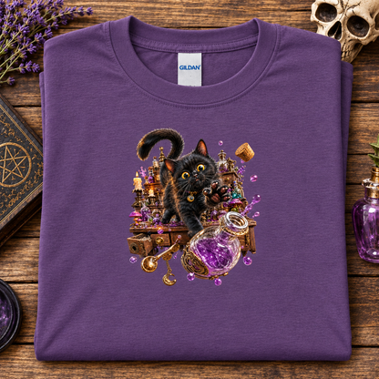 A folded heather purple Gildan t-shirt with a detailed graphic of a black cat surrounded by potions and magical items, displayed on a rustic wooden background with occult-themed props.