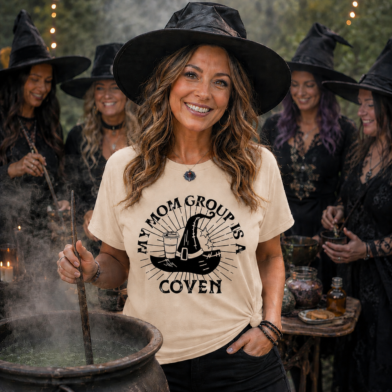Woman in a 'My Mom Group is a Coven' shirt surrounded by people in witch costumes.