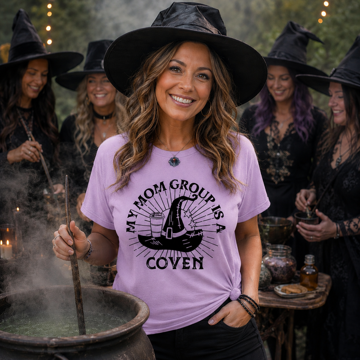Woman wearing a purple t-shirt with a witch hat design and text, surrounded by people in witch costumes.