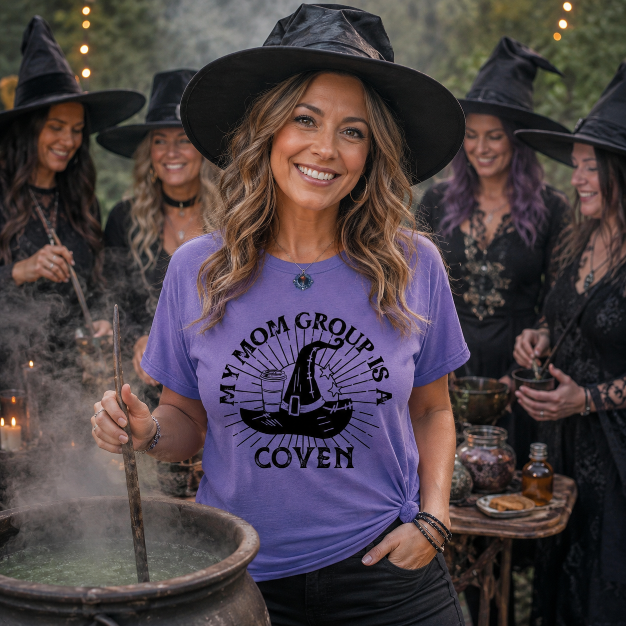 Woman wearing a purple t-shirt with a witch-themed design, surrounded by people in witch costumes.