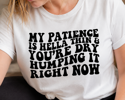 Person wearing a white t-shirt with black text design.