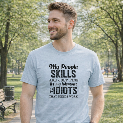 Man wearing a light blue t-shirt with humorous text design outdoors.