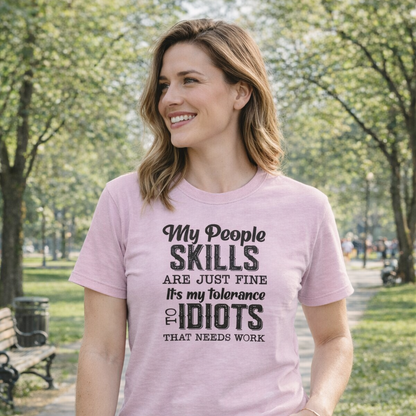 Woman wearing a pink t-shirt with humorous text in a park