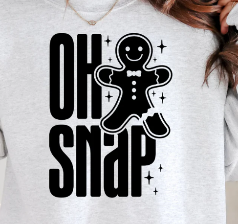 Bring the laughs with our “Oh Snap!” Gingerbread Christmas Tee! Soft, comfy, and festive — perfect for holiday parties, baking days, and gifting.