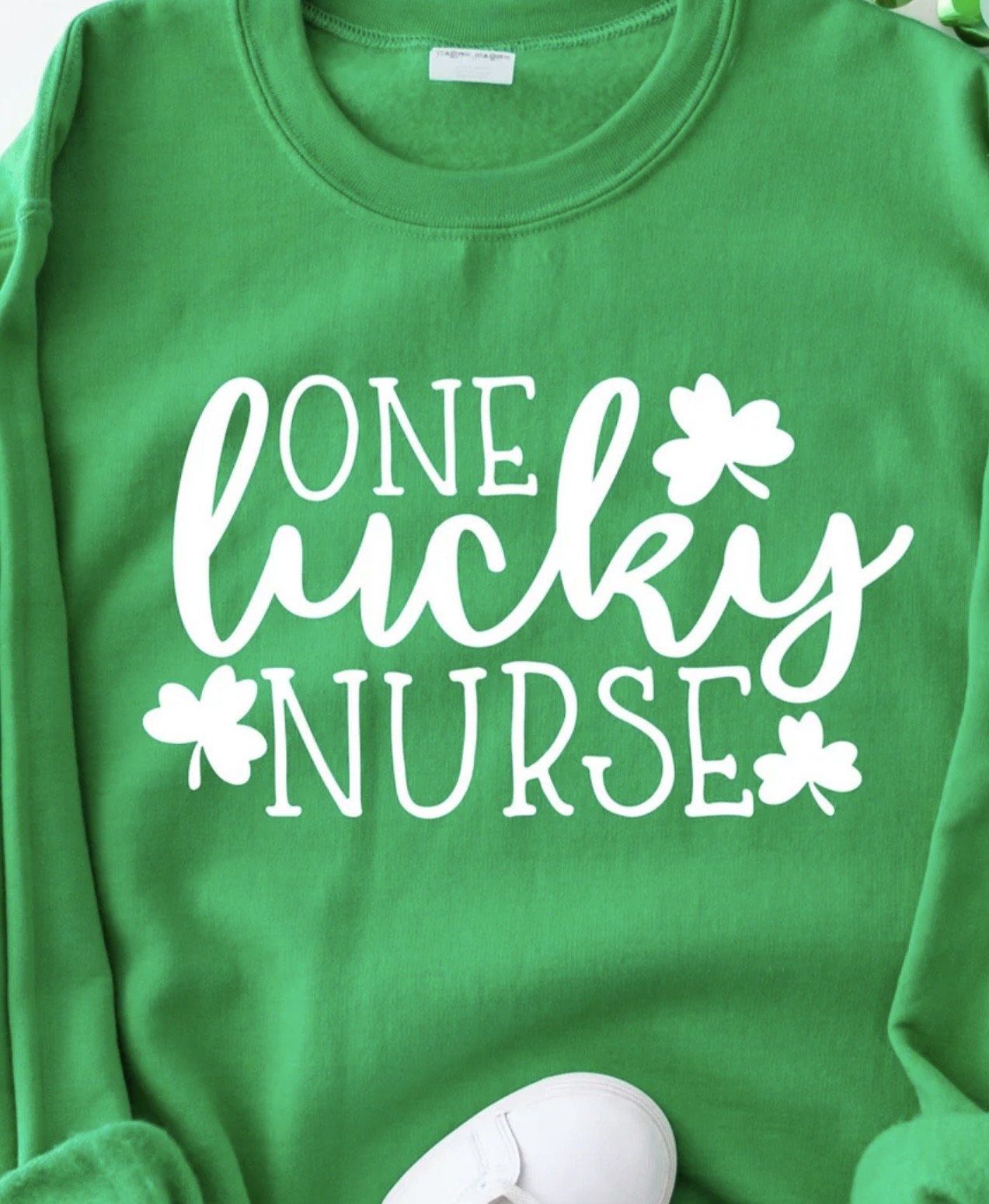 One Lucky Nurse graphic t-shirt with white ink design for St. Patrick’s Day