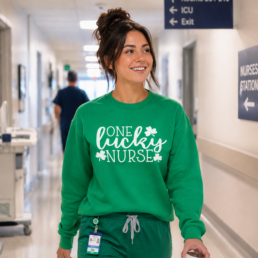Woman in a green 'One Lucky Nurse' sweatshirt walking in a hospital hallway.