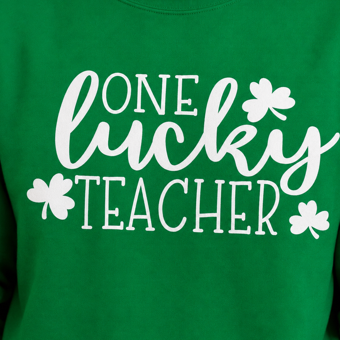 Close up of One lucky teacher' graphic design with clovers