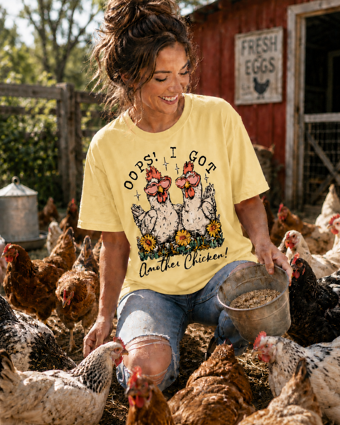Woman in butter colored shirt with chicken graphic and text oops I got another chicken