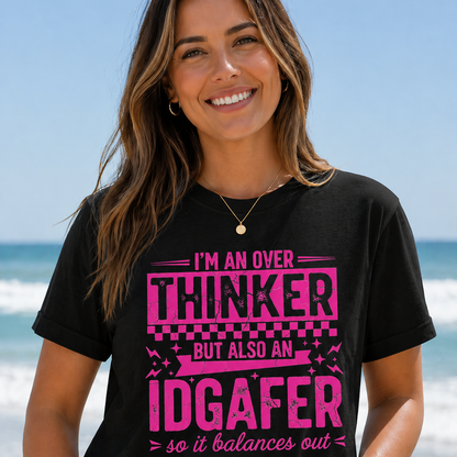 Woman wearing a black t-shirt with pink text on a beach