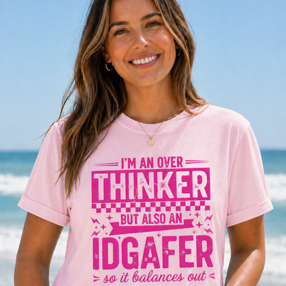 Woman wearing a pink t-shirt with text on a beach