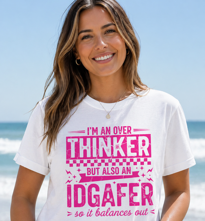 Woman wearing a white t-shirt with pink text on a beach