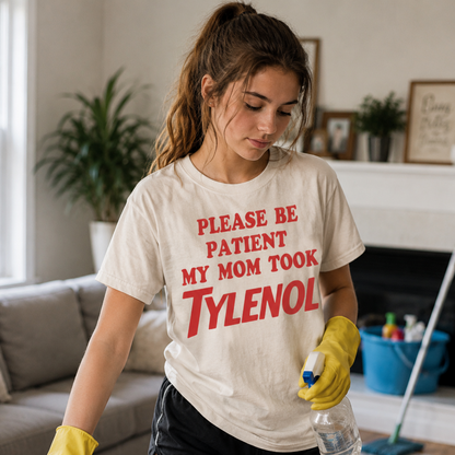 Woman cleaning a room wearing a white colored  t-shirt with a humorous message.