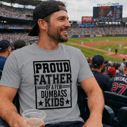 Man wearing a sport gray colored t-shirt with 'Proud Father of a Few Dumbass Kids' at a baseball game.