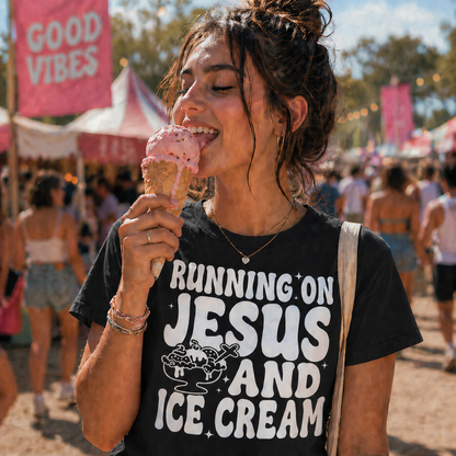 Girl wearing a black colored T-shirt with the graphic design Running on Jesus and Ice Cream