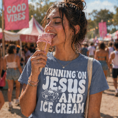 Girl wearing a blue jean colored T-shirt with the graphic design Running on Jesus and Ice Cream