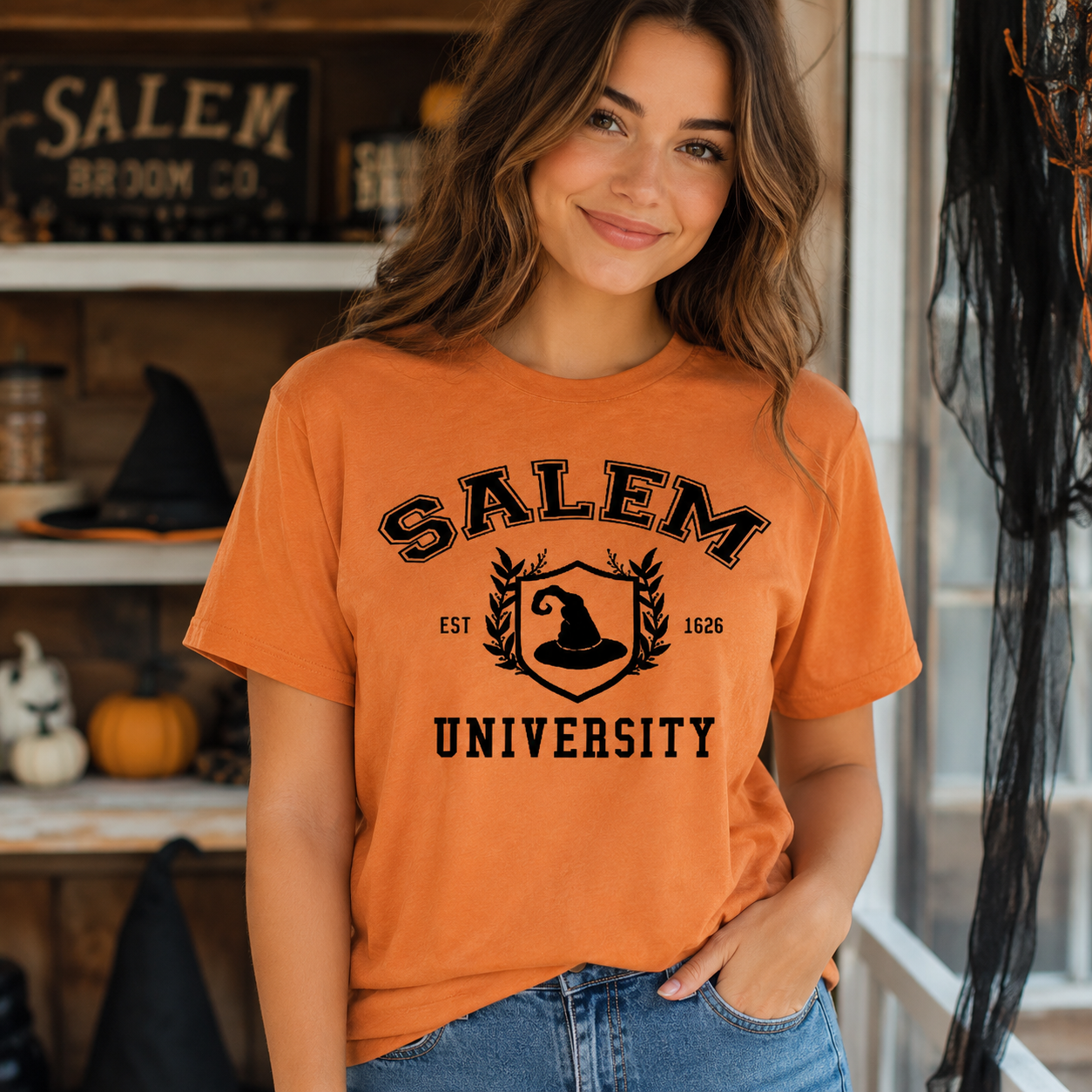woman wearing a yam colored t-shirt with Salem University graphic 
