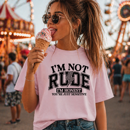 Woman wearing a pink graphic t-shirt with text at an amusement park