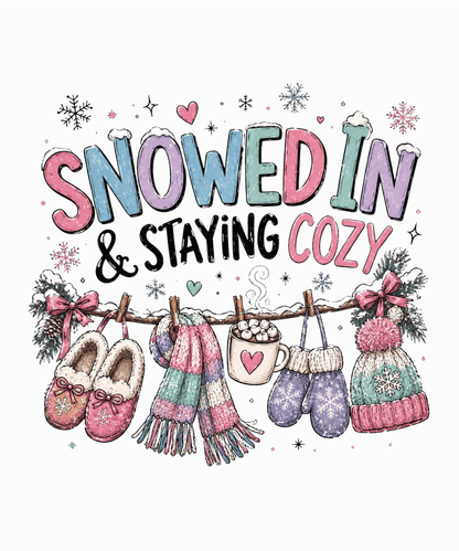 A festive winter illustration with the phrase “SNOWED IN & STAYING COZY” in pastel lettering, surrounded by snowflakes and decorated with cozy items including a scarf, mittens, slippers, a mug of hot cocoa, and hats hanging from a clothesline.