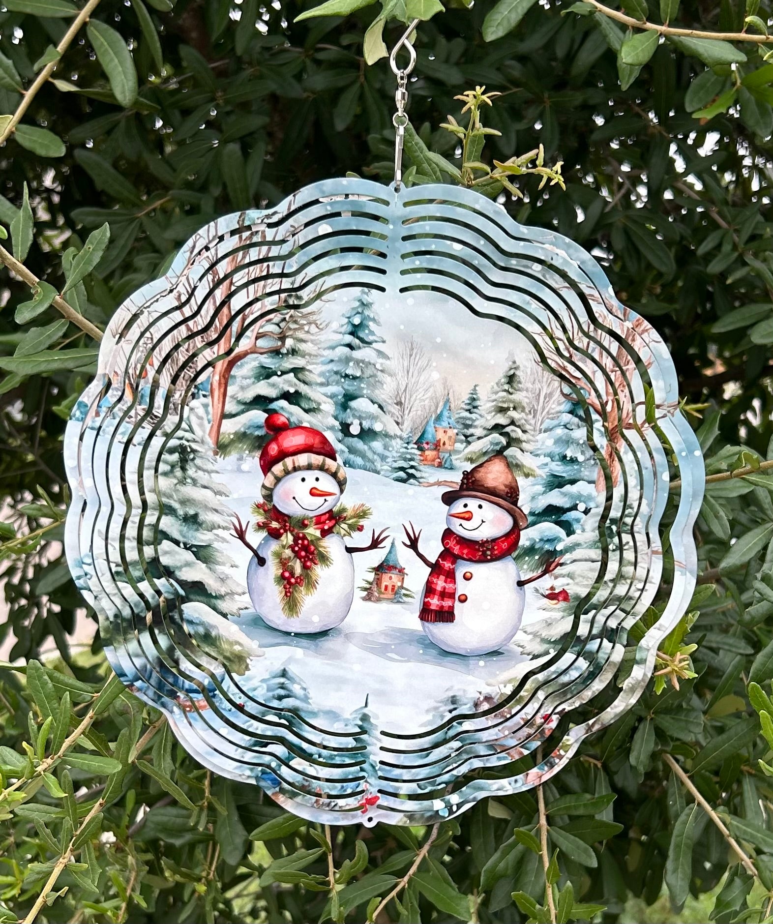 Decorative snowman ornament hanging on a tree