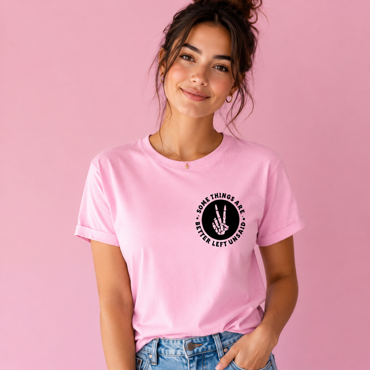 Person wearing a pink t-shirt with a black graphic and text on a pink background