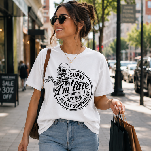 Woman walking down a street wearing a white t-shirt with a skeleton graphic and text.