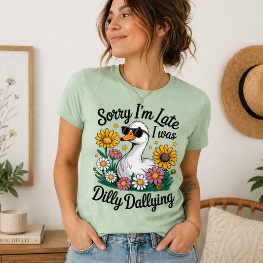 Funny goose graphic t-shirt with “Sorry I’m Late I Was Dilly Dallying” text, sunglasses-wearing goose and colorful flowers design