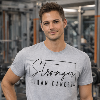 Man wearing a gray t-shirt with 'Stronger Than Cancer' in a gym setting