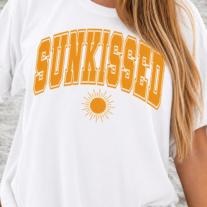 White t-shirt with 'SUNKISSED' in orange letters and a sun graphic.