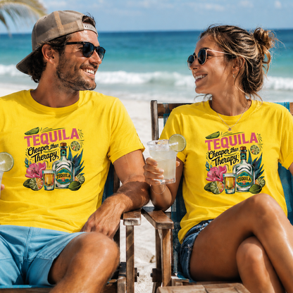 A man and a woman sitting in beach chairs at the ocean, both wearing bright yellow graphic T-shirts with a colorful 'Tequila Cheers and Cheers and Tequila' design featuring beer bottles, margaritas, and tropical fruits.