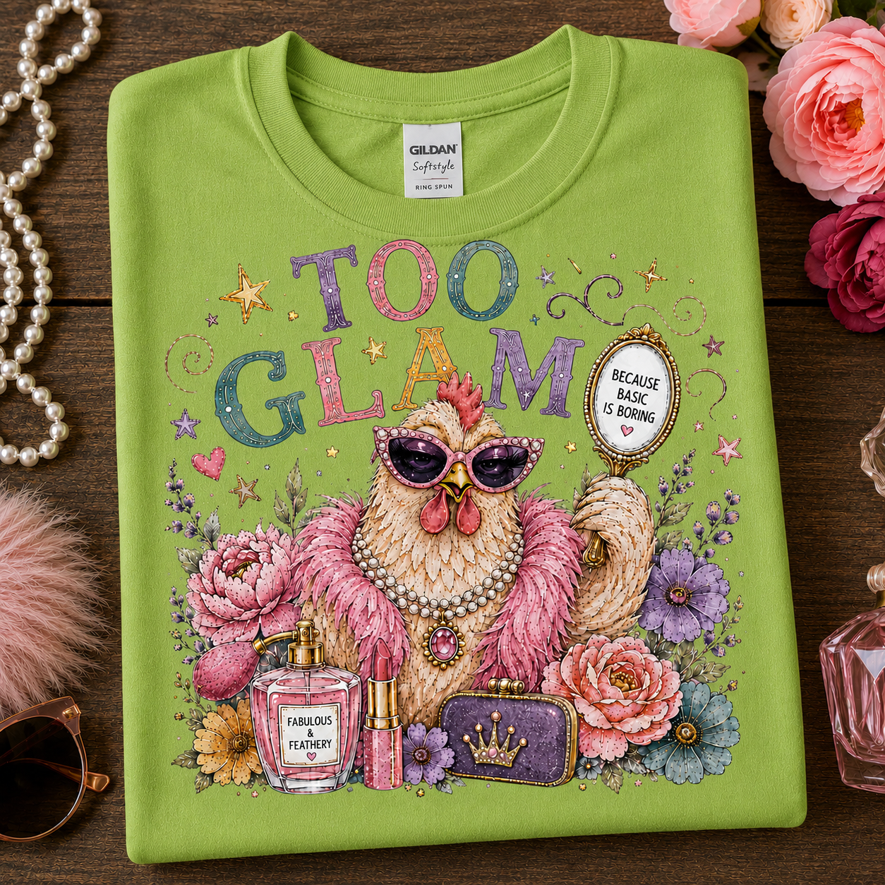 A folded lime green Gildan brand t-shirt with a colorful graphic of a glamorous chicken wearing sunglasses and a pearl necklace, surrounded by flowers, perfume bottles, and lipstick, with the text 'TOO GLAM' and 'BROOKLYN IS BORN'.